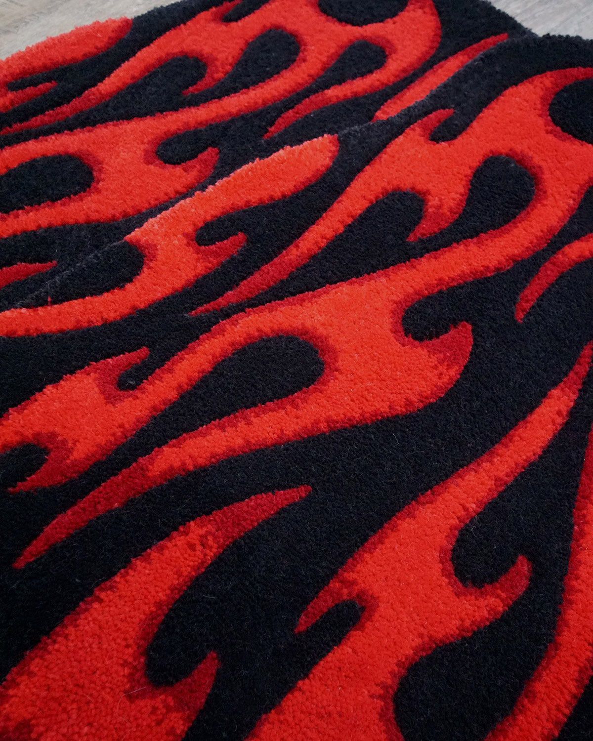 Pair of hand-made car floor mats featuring a vibrant flame design in black and red gradient tribal flames, with a retro-inspired aesthetic.