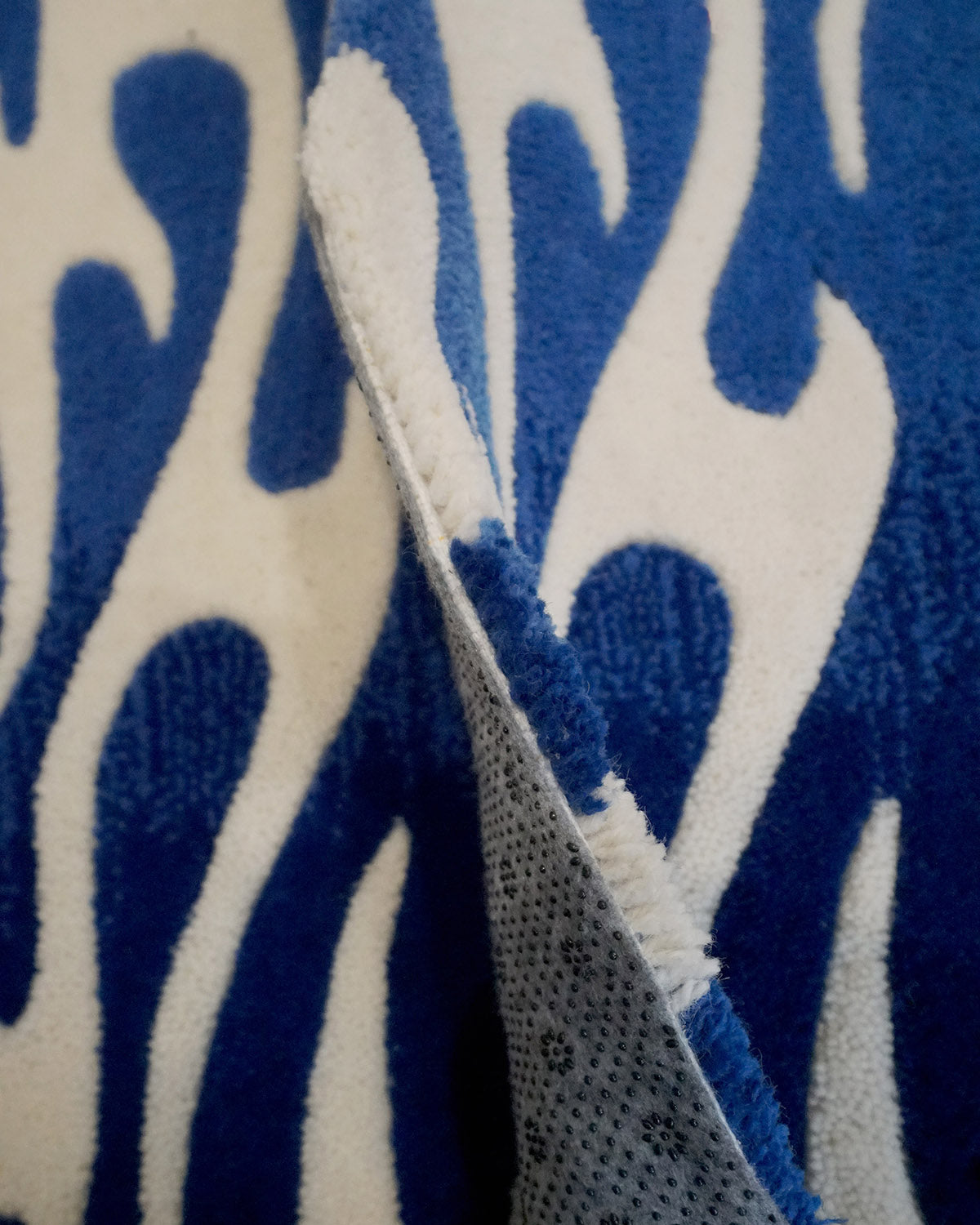 Pair of hand-made car floor mats featuring a vibrant flame design in blue gradient and white tribal flames, with a retro-inspired aesthetic.