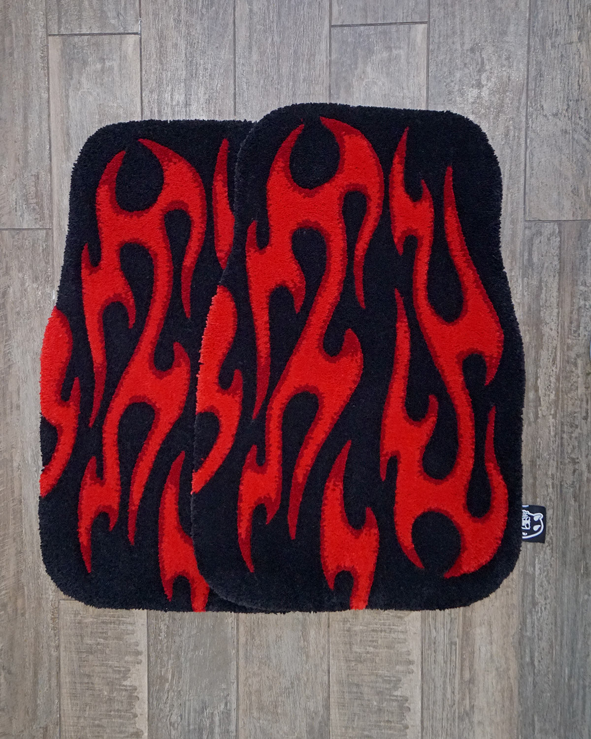 Pair of hand-made car floor mats featuring a vibrant flame design in black and red gradient tribal flames, with a retro-inspired aesthetic.